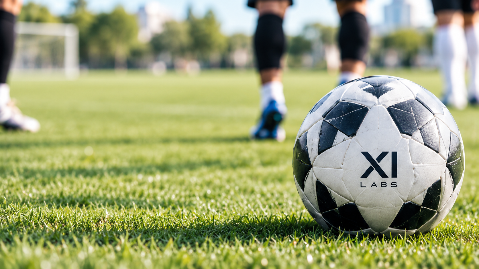 Football on a grass pitch with an XI Labs branded ball